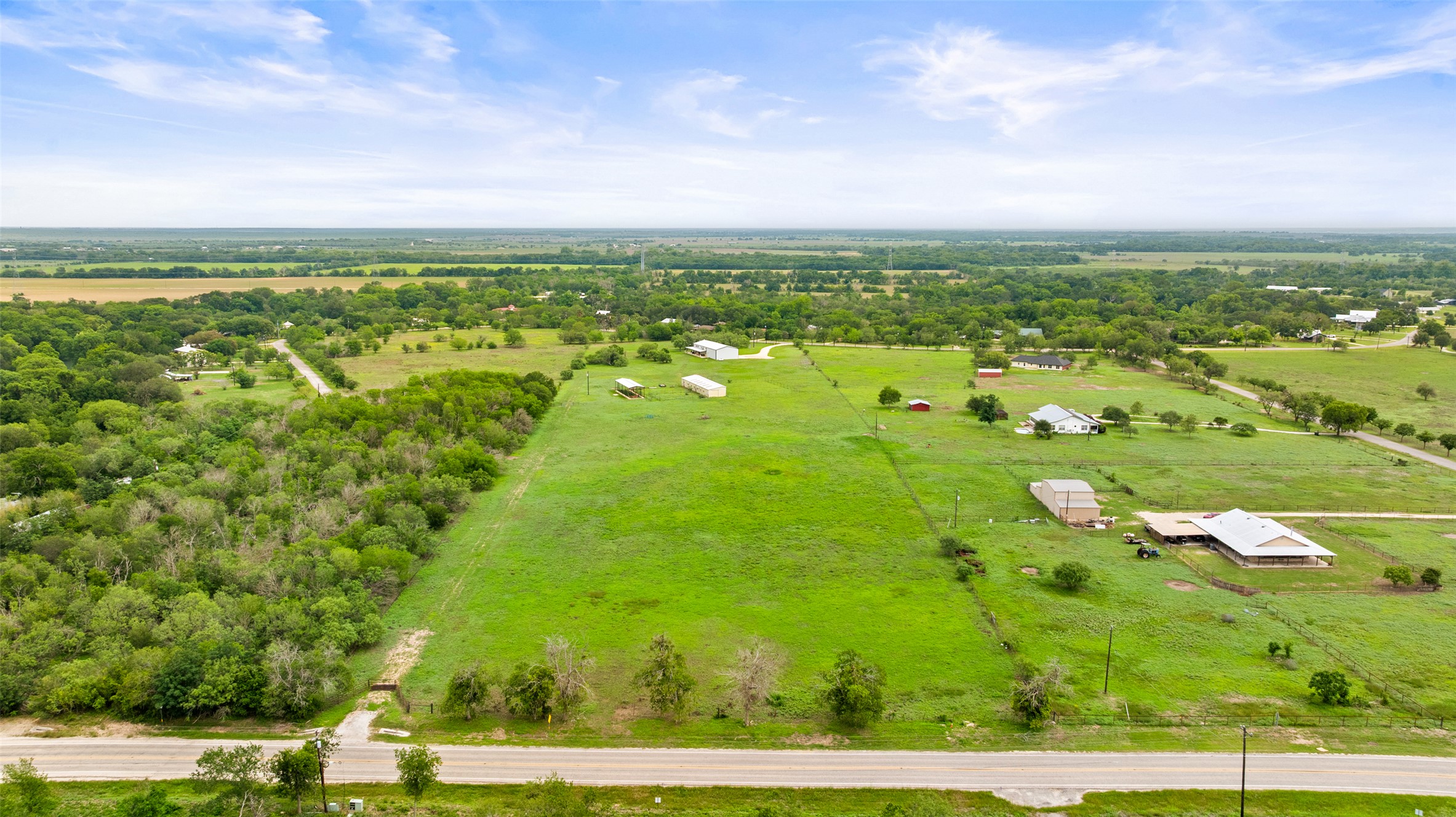 664 Martindale Falls Road Martindale, TX 78655 - Photo 14 of 21 Expansive green acreage with a tree line border and distant rural structures