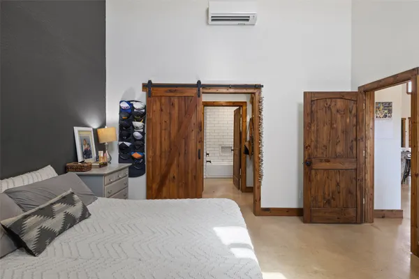 a bedroom with bed and washing machine