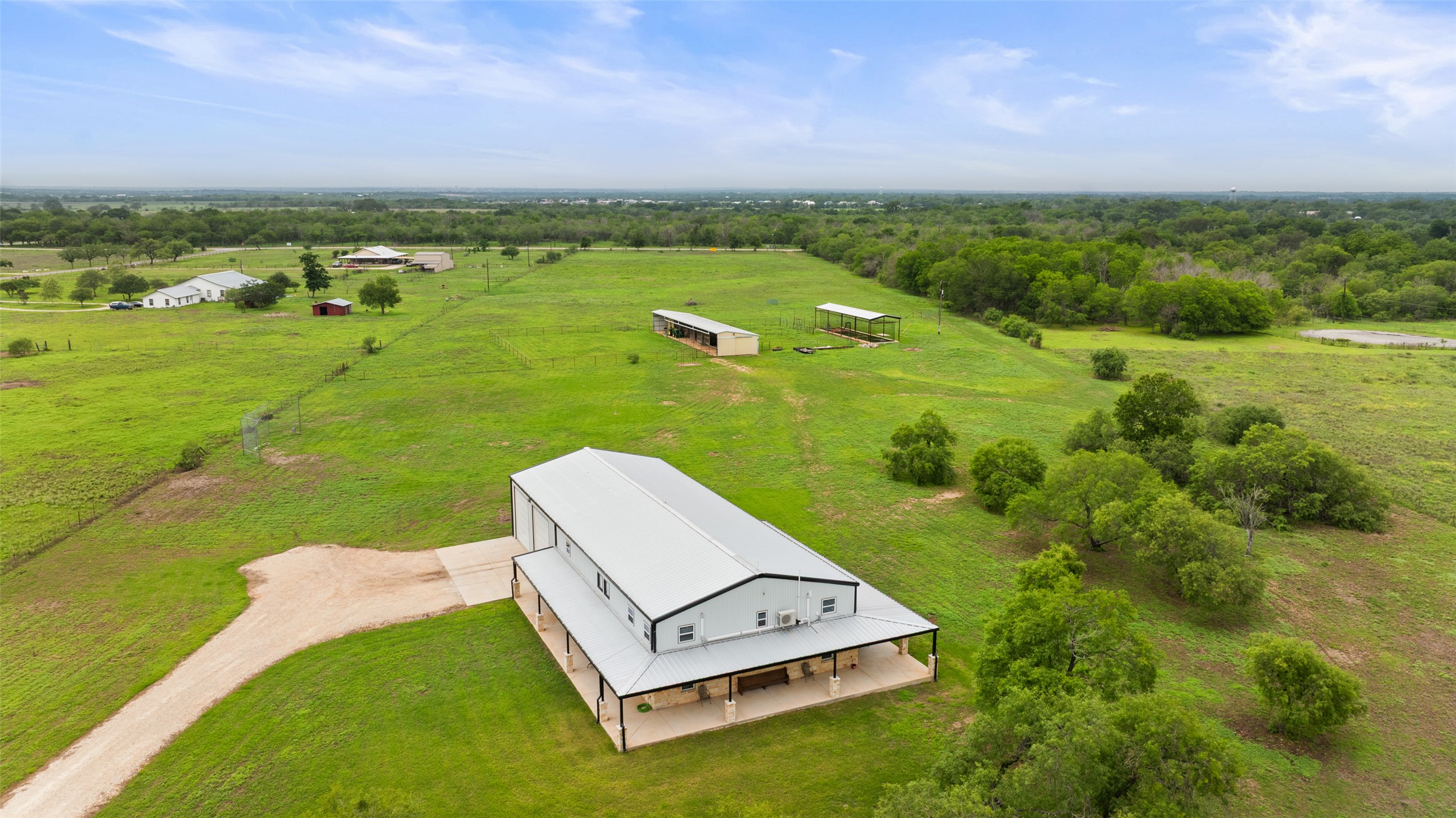 664 Martindale Falls Road Martindale, TX 78655 - Photo 9 of 21 Expansive barn-style structure featuring a metal roof and an extended covered porch