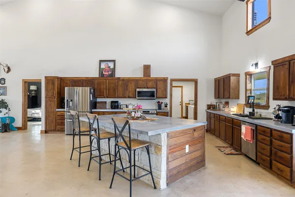 a large kitchen with a table and chairs in it