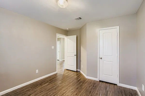 a view of an empty room and wooden floor