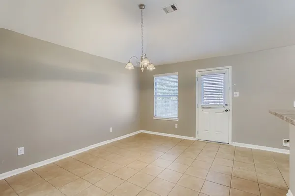 a view of a room with window and chandelier fan