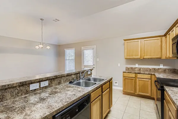 a kitchen with a sink stove and cabinets