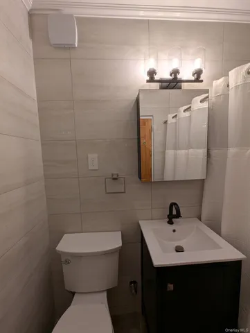 a bathroom with a sink a toilet and mirror