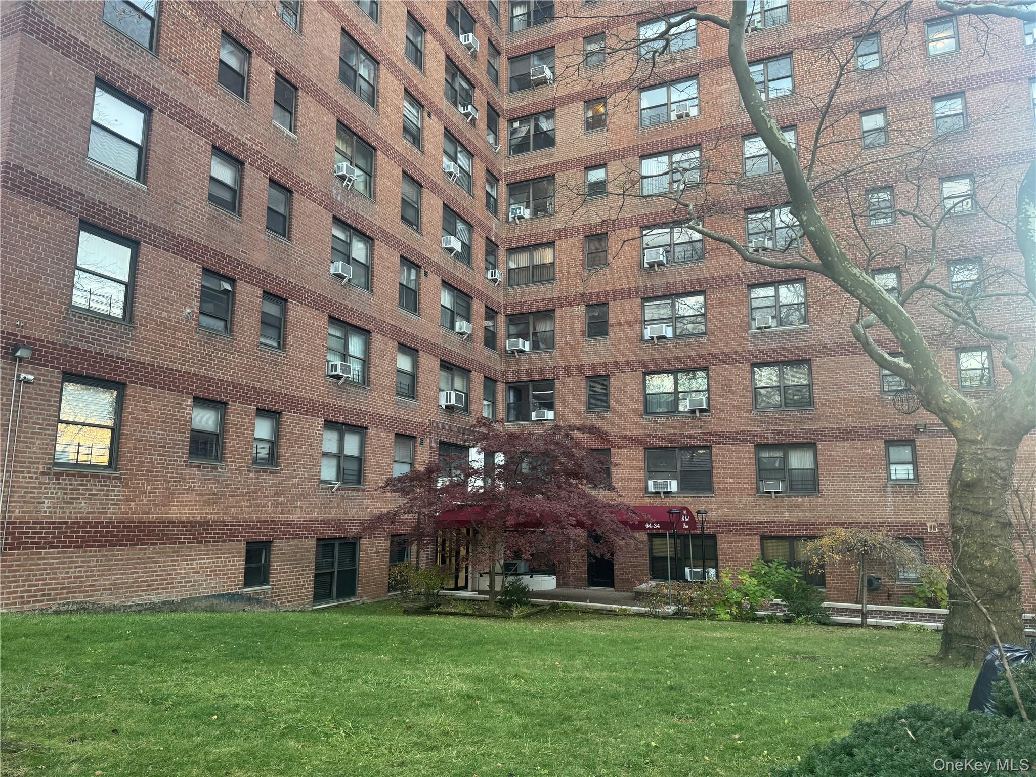 64-34 102nd Street, Unit 7F Queens, NY 11374 - Photo 3 of 17 a view of building with a yard