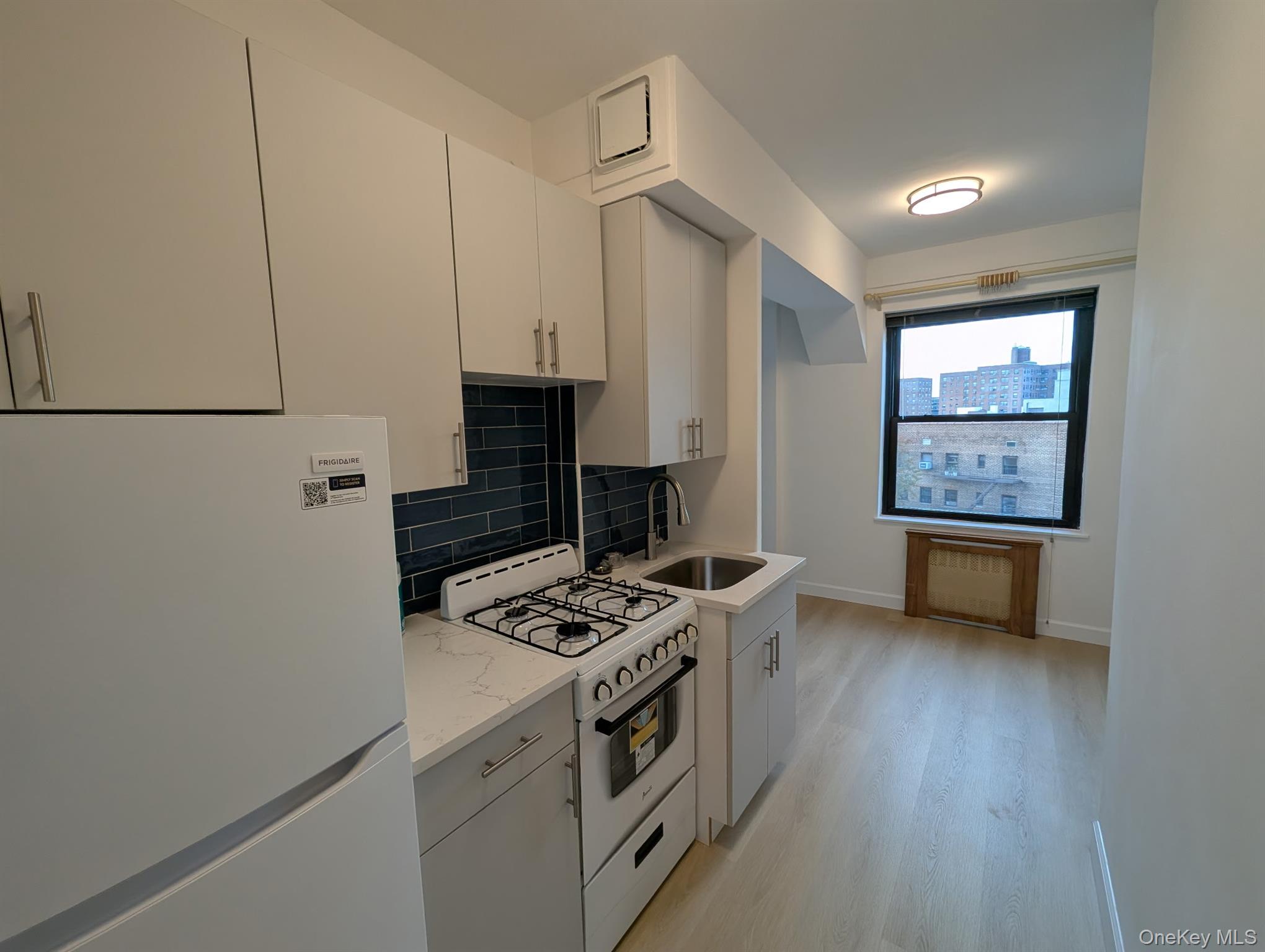 64-34 102nd Street, Unit 7F Queens, NY 11374 - Photo 6 of 17 a kitchen with a stove and a refrigerator