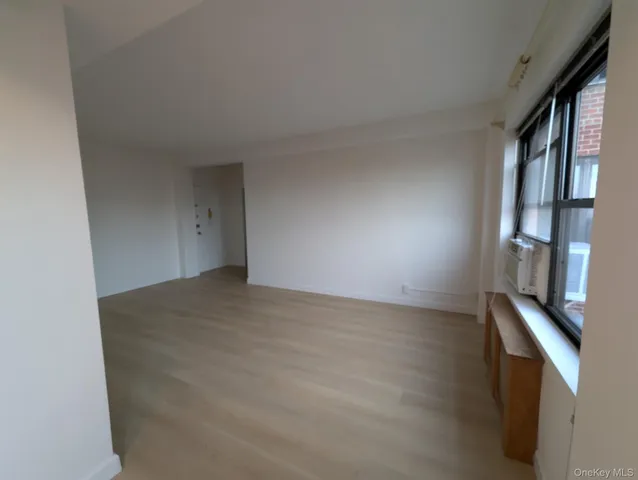 a view of an empty room and wooden floor