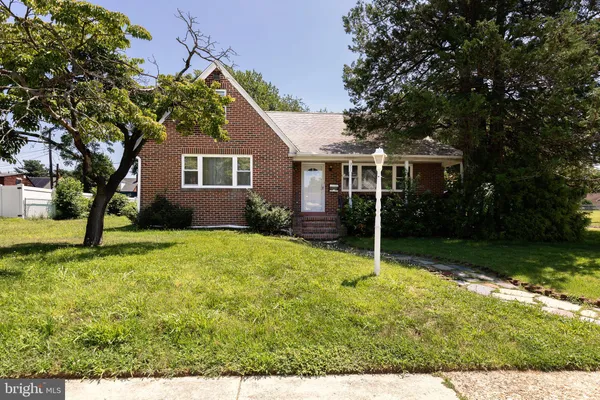 a house that has a tree in front of it