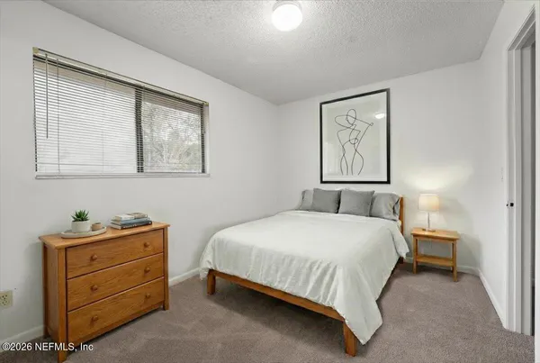 a bedroom with a bed and window