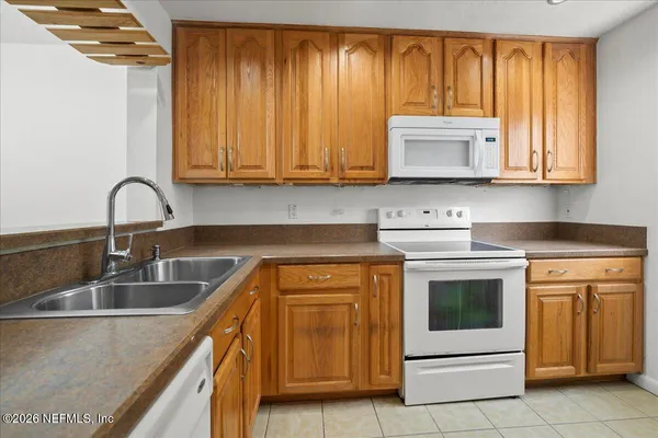 a kitchen with stainless steel appliances granite countertop a sink a stove and oven