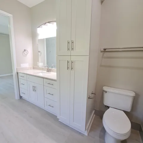 a spacious bathroom with a toilet sink and mirror