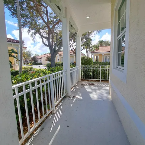 a view of a porch with wooden floor and fence