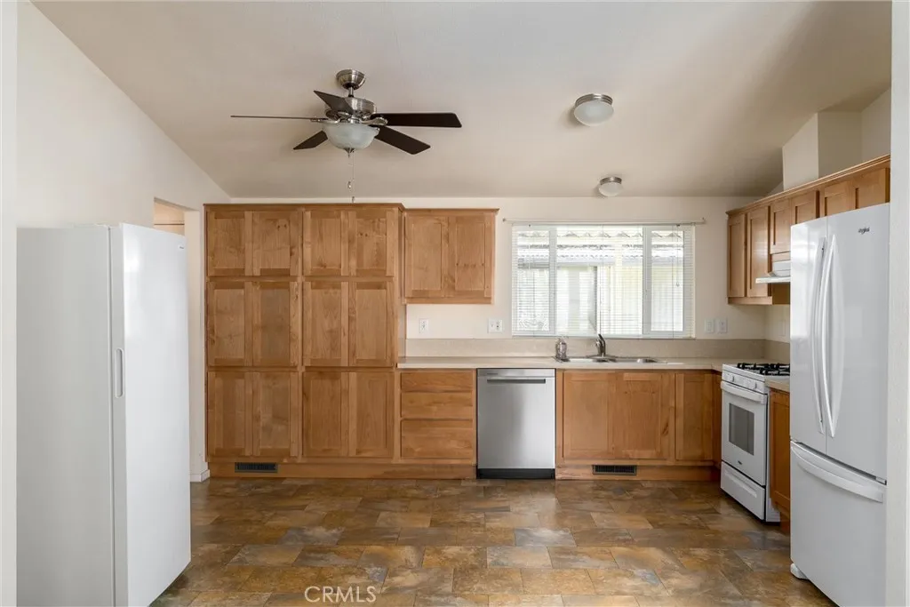 567 East Lassen Avenue, Unit 109 Chico, CA 95928 - Photo 11 of 34 a kitchen with a refrigerator a sink and dishwasher