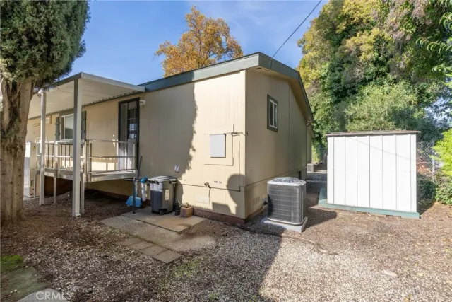 a view of a house with backyard and sitting area
