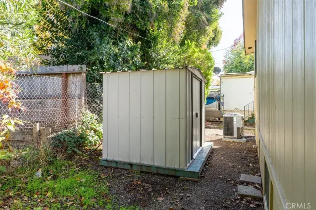 a view of a backyard with plants and wooden fence