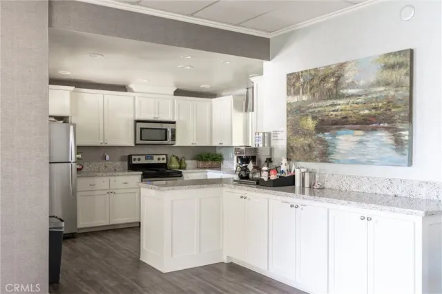 a kitchen with stainless steel appliances white cabinets a sink and a granite counter tops
