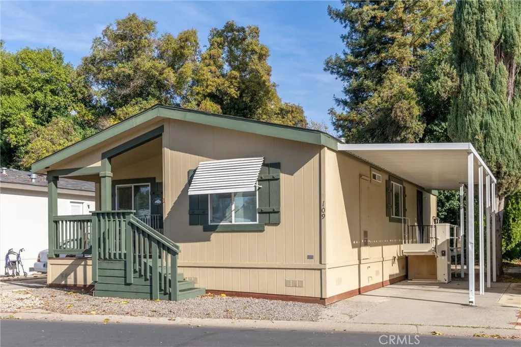 567 East Lassen Avenue, Unit 109 Chico, CA 95928 - Photo 3 of 34 a view of a white house with large windows and a small yard