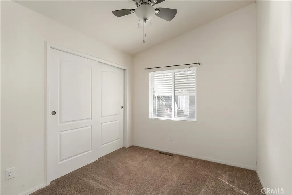 567 East Lassen Avenue, Unit 109 Chico, CA 95928 - Photo 10 of 34 an empty room with a window and a ceiling fan