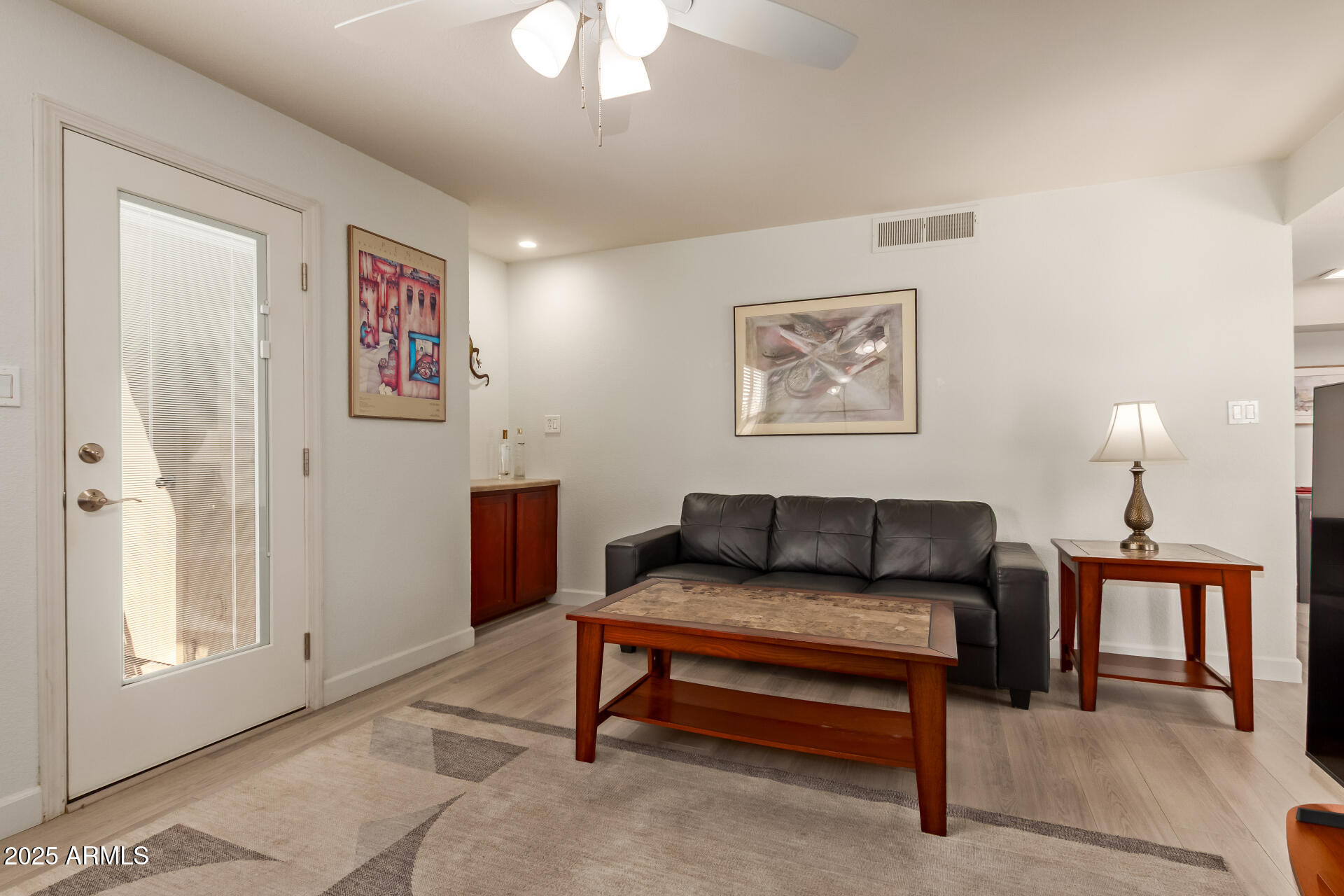 8787 East Mountain View Road, Unit 2015 Scottsdale, AZ 85258 - Photo 11 of 31 a living room with furniture and a lamp
