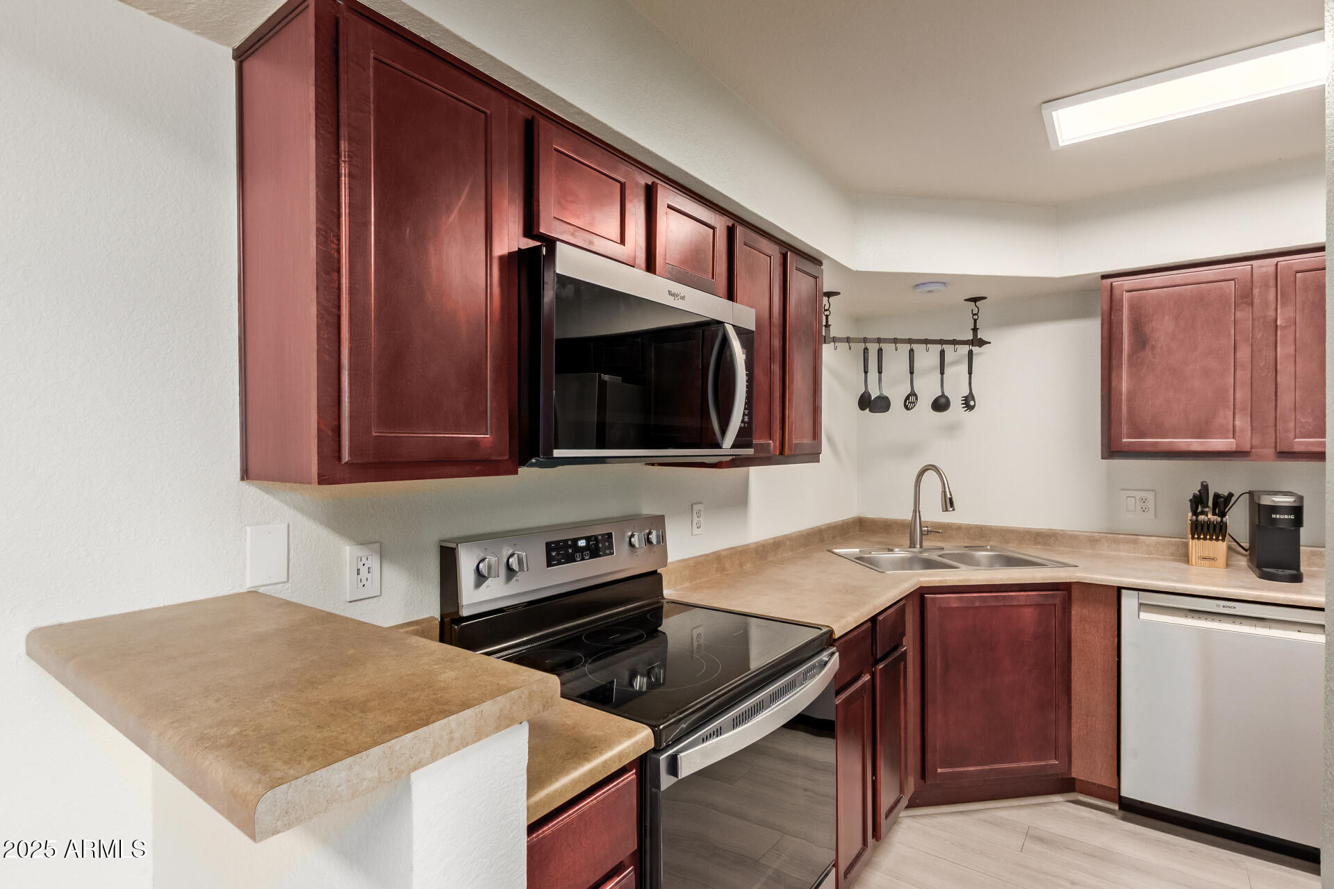 8787 East Mountain View Road, Unit 2015 Scottsdale, AZ 85258 - Photo 13 of 31 a kitchen with a stove a sink and a microwave