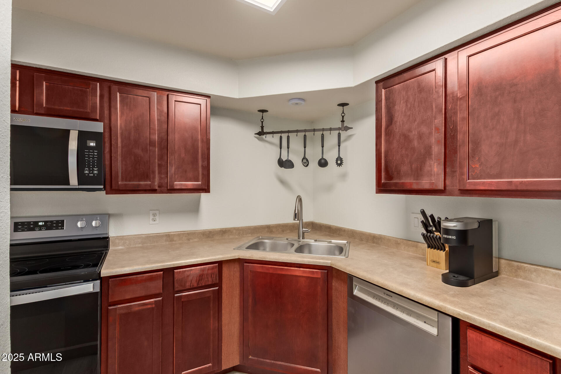 8787 East Mountain View Road, Unit 2015 Scottsdale, AZ 85258 - Photo 14 of 31 a kitchen with stainless steel appliances granite countertop a sink stove and microwave