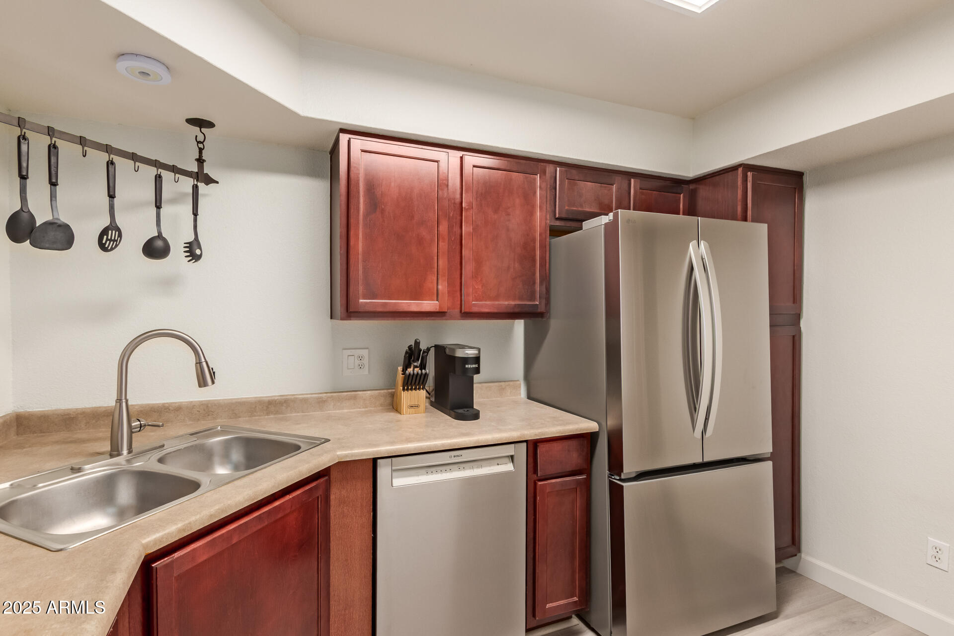 8787 East Mountain View Road, Unit 2015 Scottsdale, AZ 85258 - Photo 15 of 31 a kitchen with stainless steel appliances granite countertop a refrigerator sink and cabinets