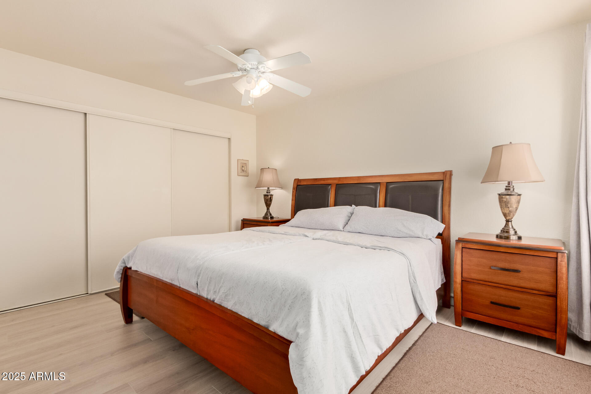 8787 East Mountain View Road, Unit 2015 Scottsdale, AZ 85258 - Photo 16 of 31 a bedroom with a bed and a chandelier