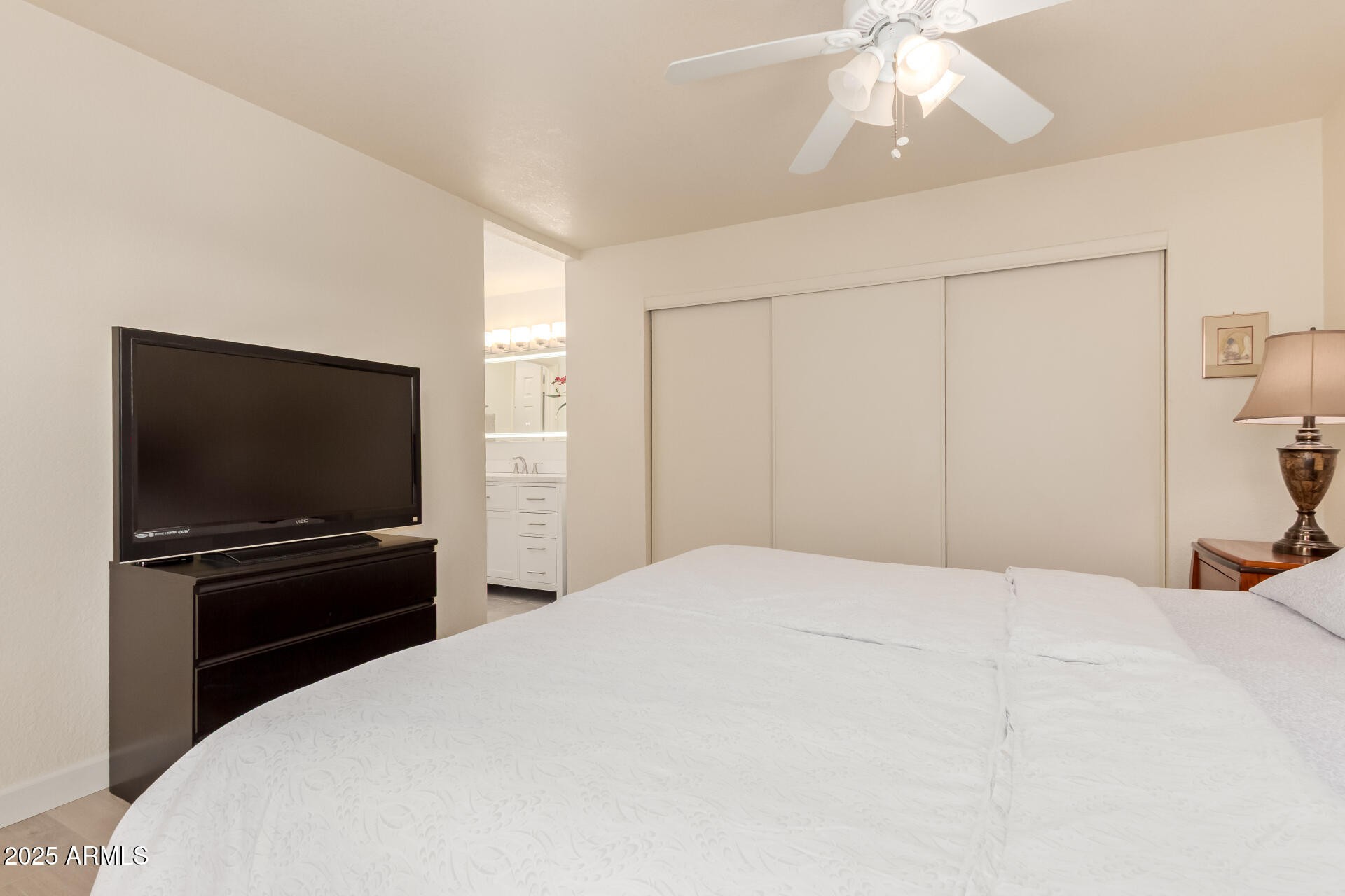 8787 East Mountain View Road, Unit 2015 Scottsdale, AZ 85258 - Photo 19 of 31 a bedroom with a bed and a flat screen tv