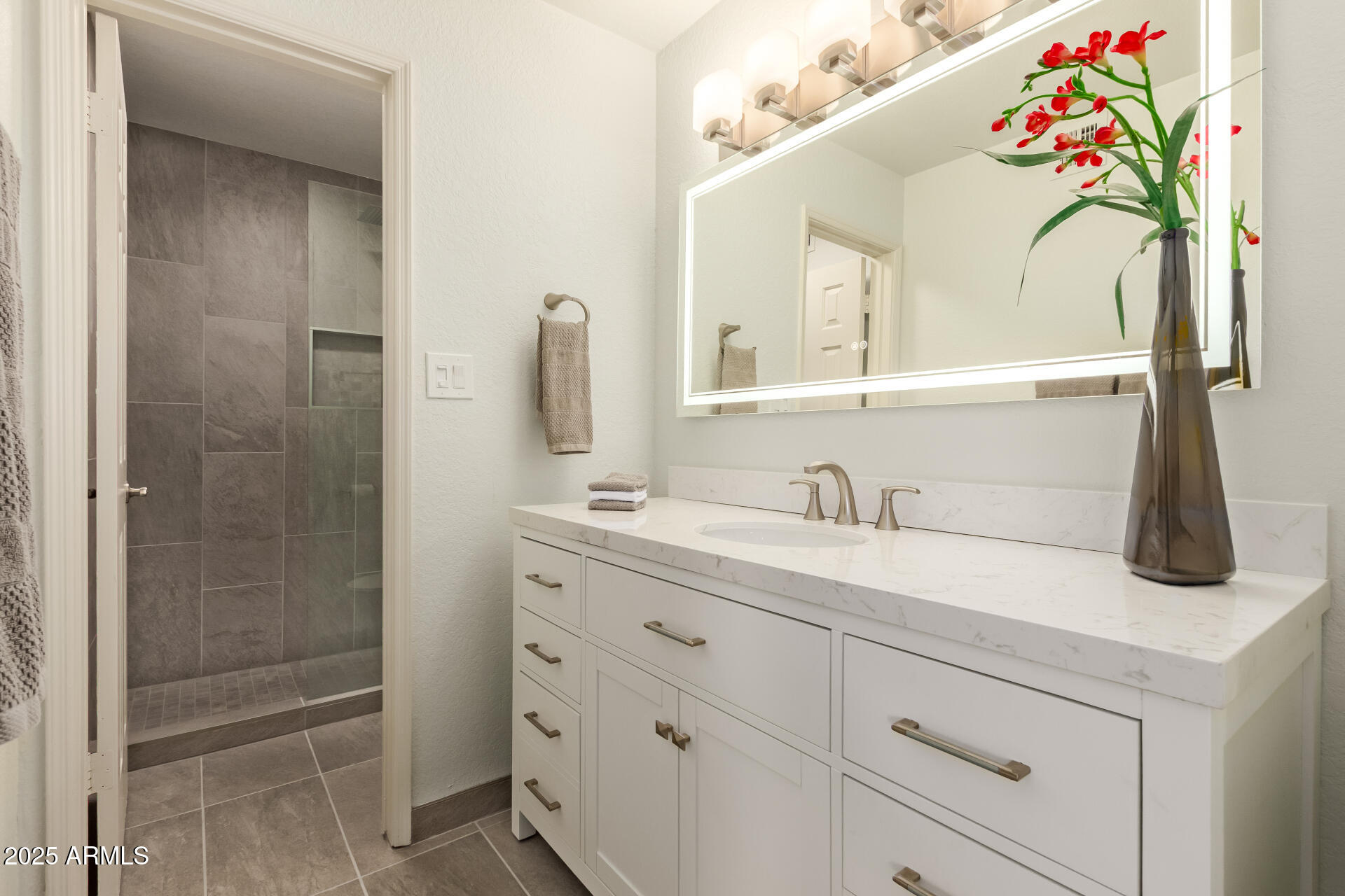 8787 East Mountain View Road, Unit 2015 Scottsdale, AZ 85258 - Photo 20 of 31 a bathroom with a sink vanity and a mirror