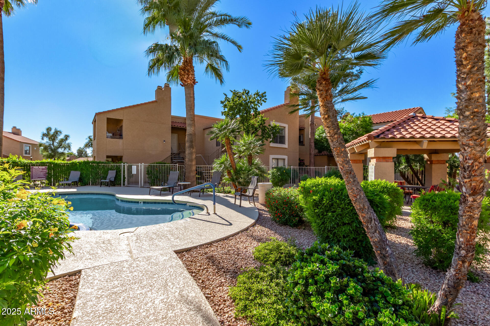 8787 East Mountain View Road, Unit 2015 Scottsdale, AZ 85258 - Photo 26 of 31 a front view of a house with fountain and potted plants