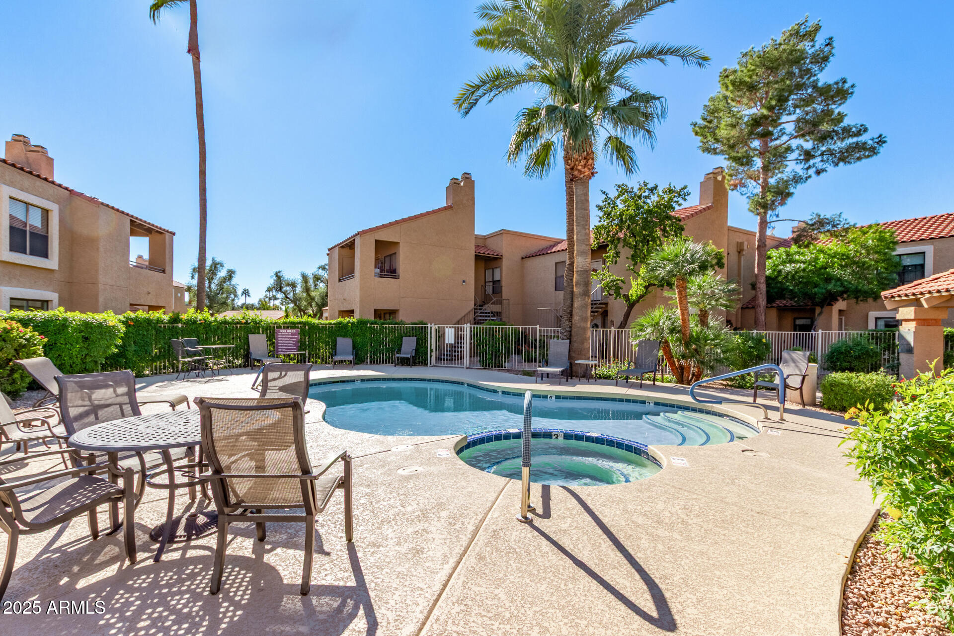 8787 East Mountain View Road, Unit 2015 Scottsdale, AZ 85258 - Photo 3 of 31 a view of a patio with a table and chairs under an umbrella