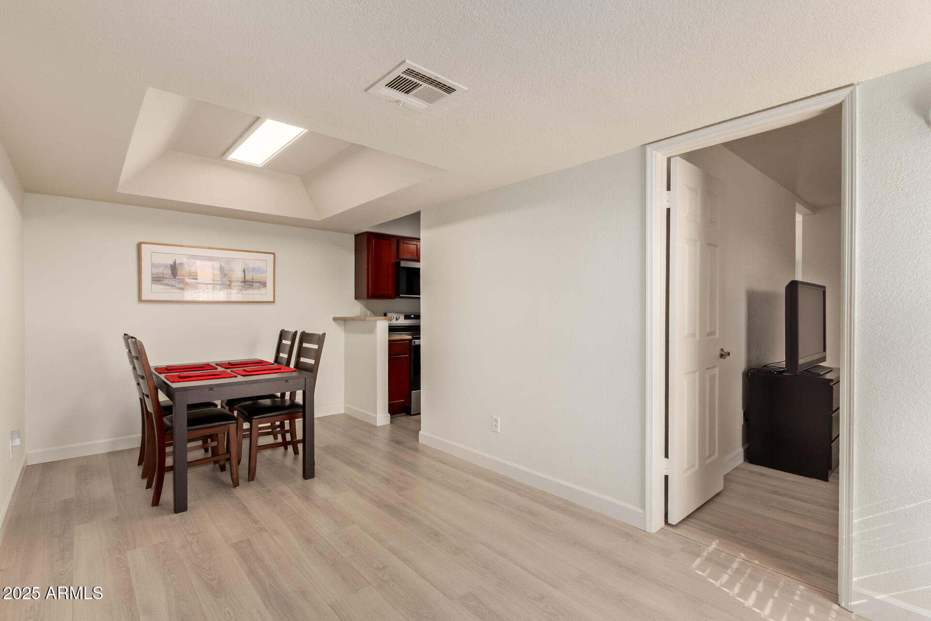 8787 East Mountain View Road, Unit 2015 Scottsdale, AZ 85258 - Photo 7 of 31 a view of a dining room with furniture and a chandelier