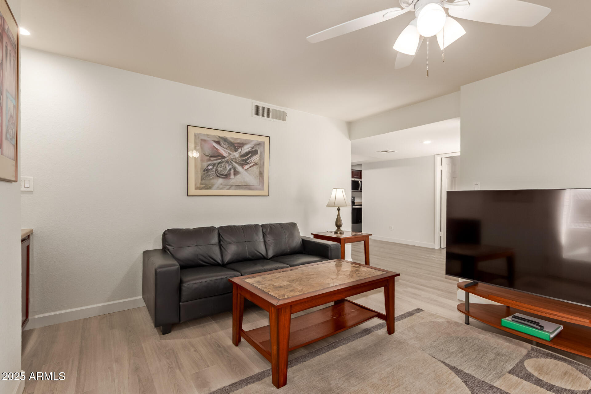 8787 East Mountain View Road, Unit 2015 Scottsdale, AZ 85258 - Photo 10 of 31 a living room with furniture and a flat screen tv