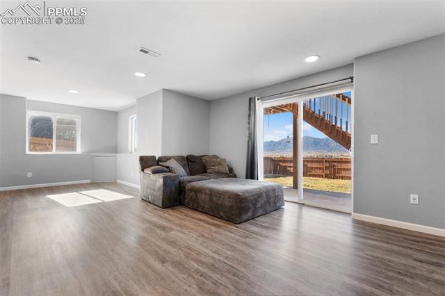 4540 Sierra Rica Road Colorado Springs, CO 80911 - Photo 19 of 42 Living area with a mountain view, wood finished floors, and recessed lighting