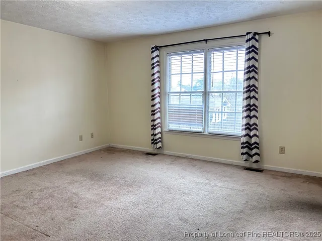 an empty room with windows and natural light