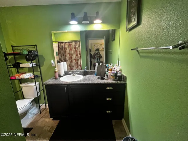 a bathroom with a sink vanity and mirror