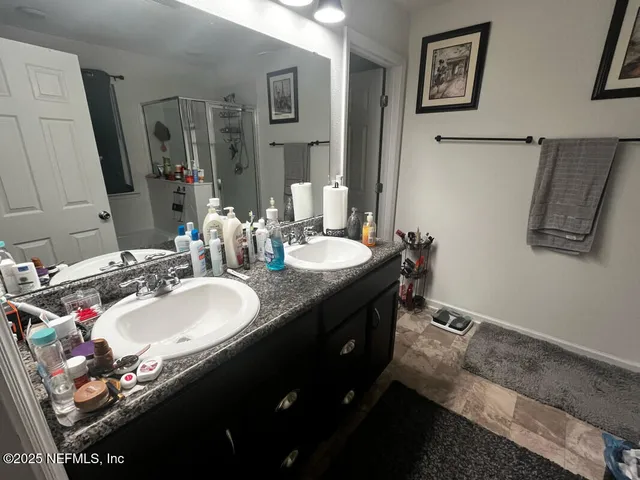 a bathroom with a double vanity sink and a mirror