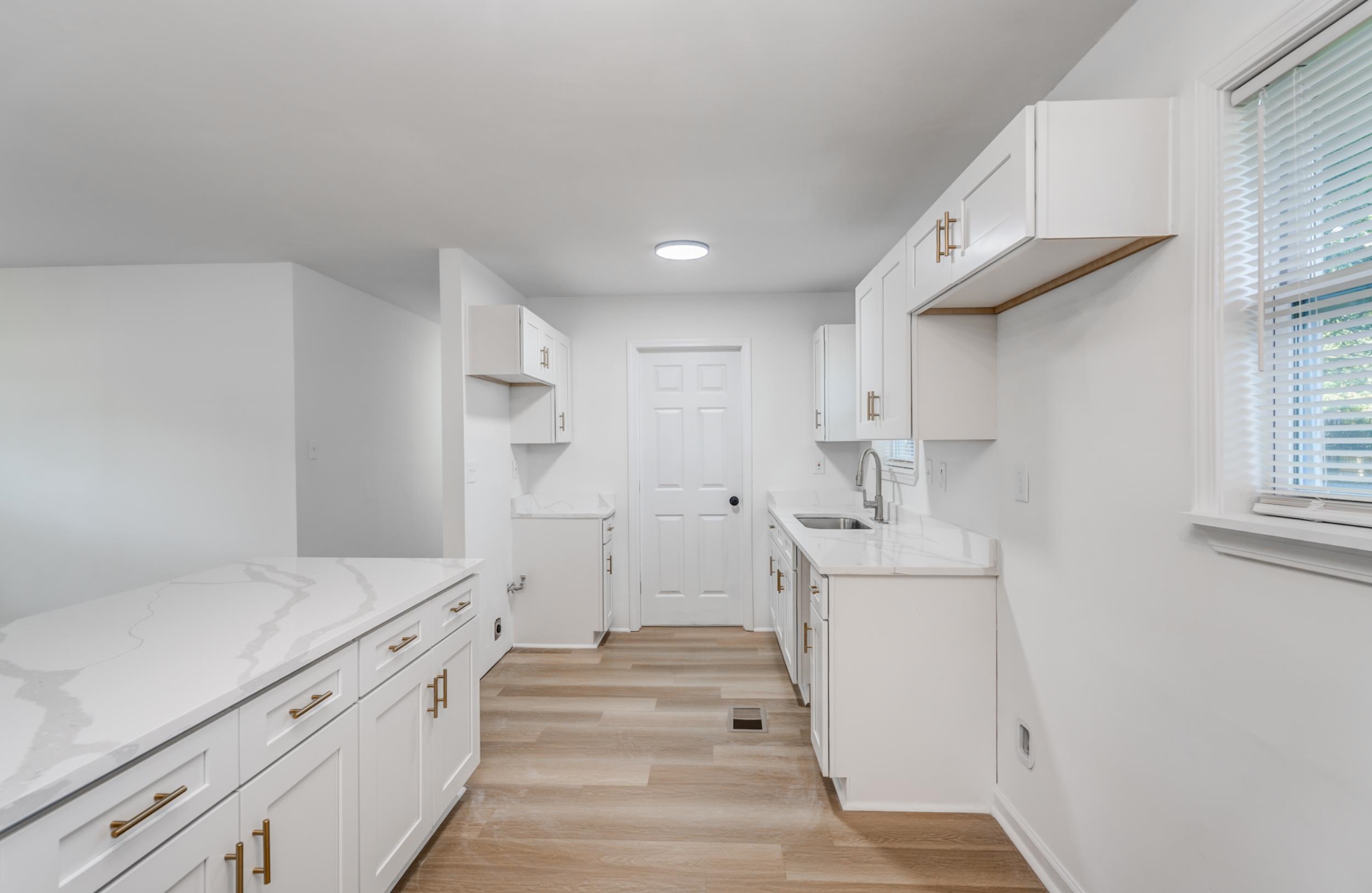 3994 Oak Road Bartlett, TN 38135 - Photo 4 of 10 a kitchen with white cabinets and sink