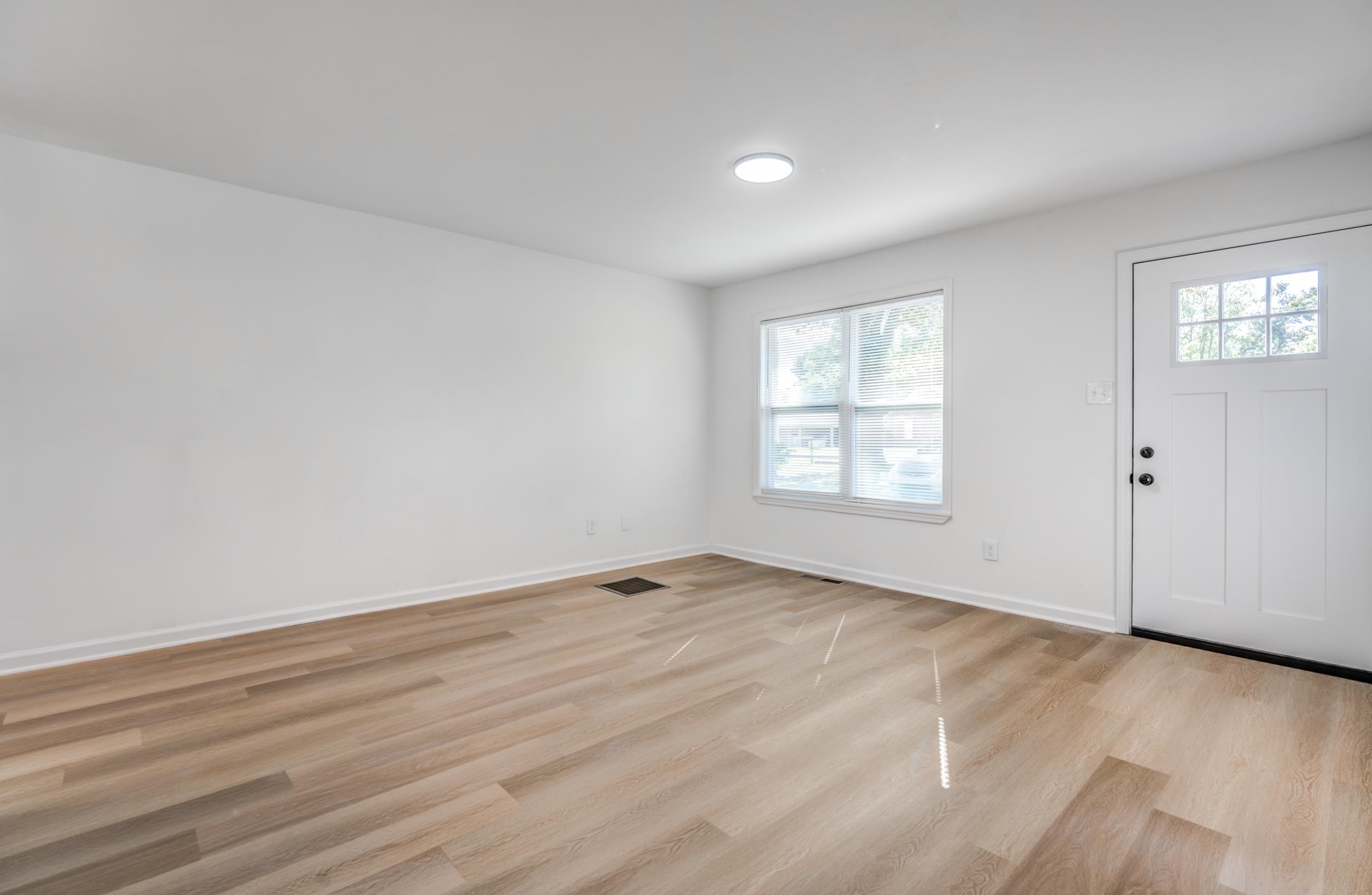 3994 Oak Road Bartlett, TN 38135 - Photo 6 of 10 a view of an empty room with wooden floor and a window