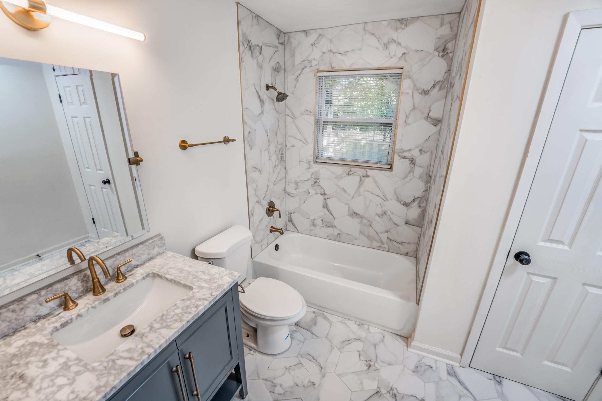 3994 Oak Road Bartlett, TN 38135 - Photo 7 of 10 a bathroom with a sink toilet tub and shower