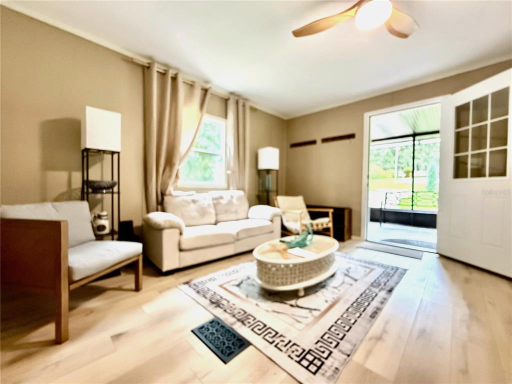 208 Ashley Street Hawthorne, FL 32640 - Photo 5 of 32 a living room with furniture and a large window