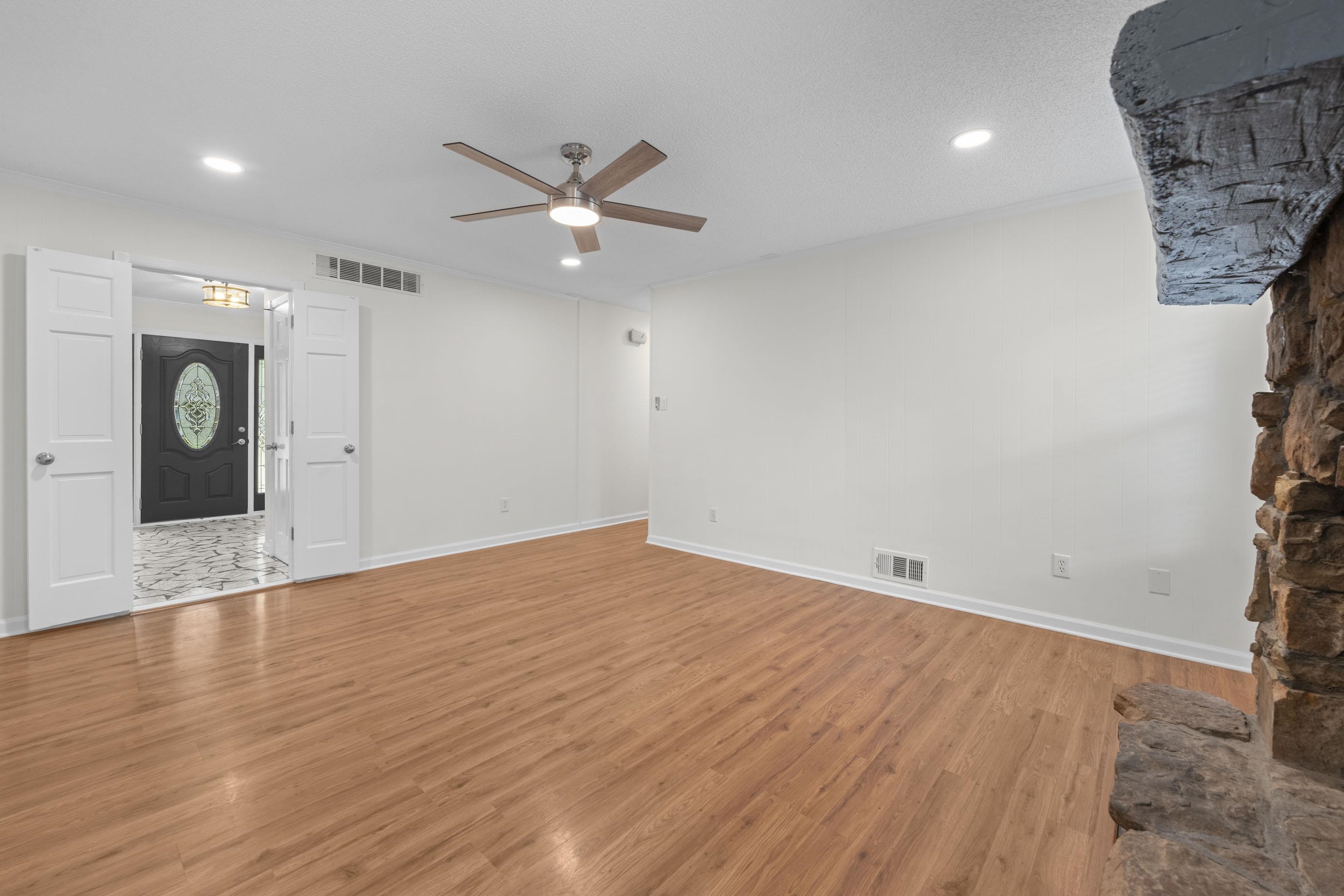 499 Duscoe Street Collierville, TN 38017 - Photo 7 of 38 an empty room with wooden floor and windows