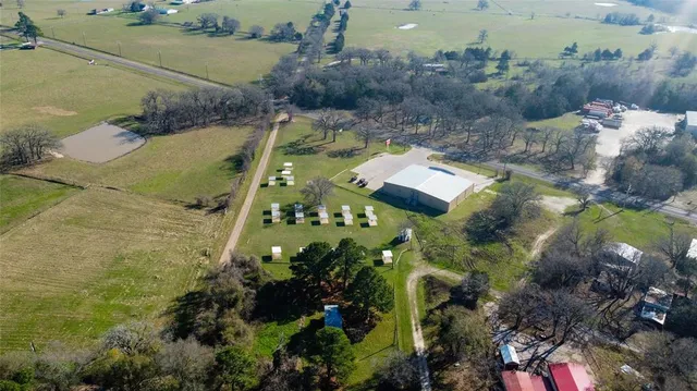 an aerial view of a house with a yard
