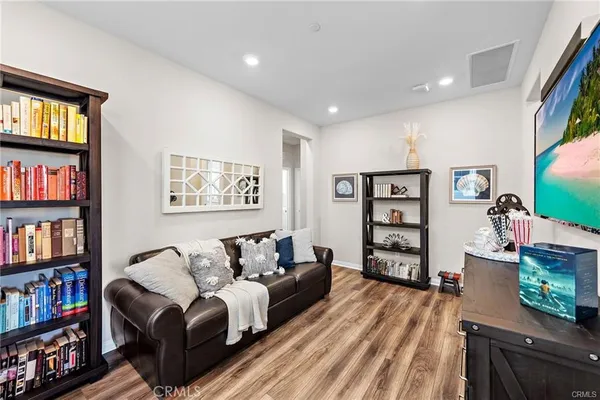 a living room with furniture and a book shelf