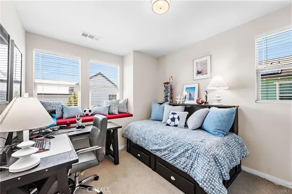 a bedroom with a bed and a table