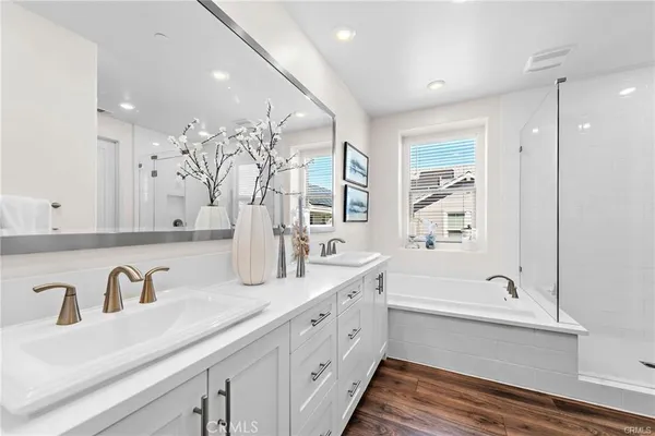 a bathroom with a bathtub sink and mirror