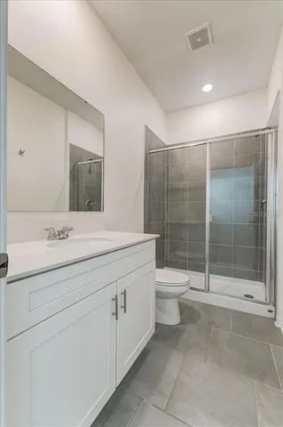 a bathroom with a toilet sink and shower