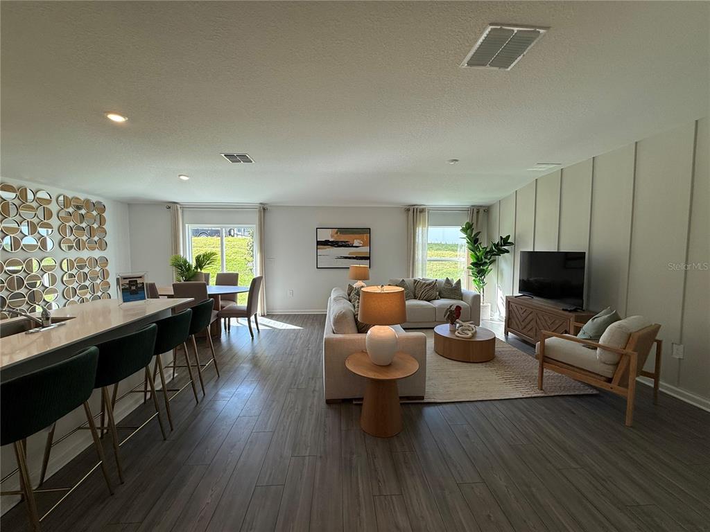 4612 Southwest 84th St Road Ocala, FL 34476 - Photo 8 of 12 a living room with furniture and a wooden floor