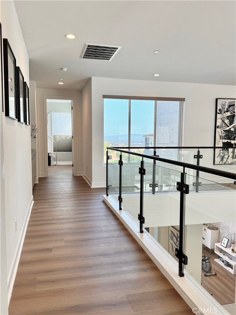 20401 Aberdeen Lane Porter Ranch, CA 91326 - Photo 12 of 21 a hallway with wooden floor and furniture