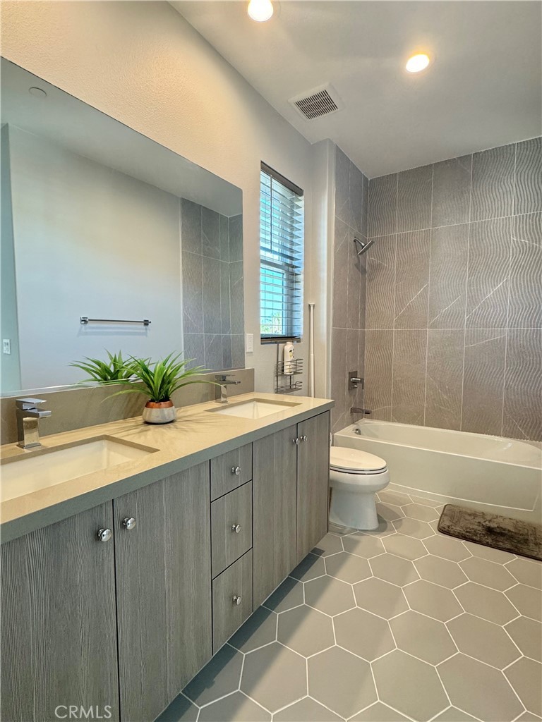 20401 Aberdeen Lane Porter Ranch, CA 91326 - Photo 15 of 21 a bathroom with a double vanity sink toilet and shower